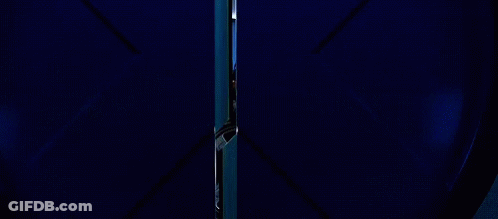 Bald Man In Suit And Tie Sitting In Chair GIF