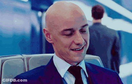 Bald Man In Suit And Tie Smiles GIF