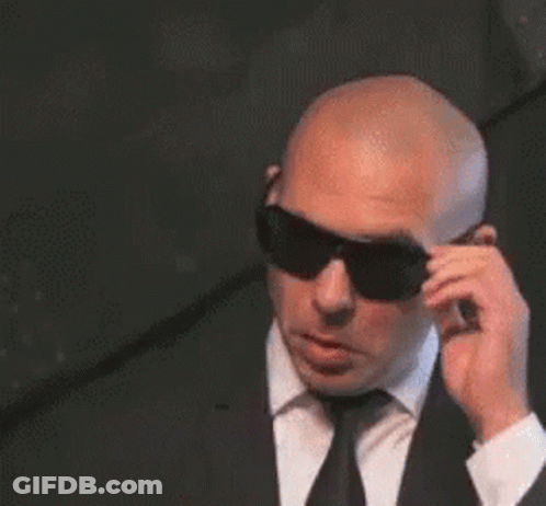 Bald Man In Suit And Tie Wearing Sunglasses GIF