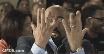 Bald Man In Suit Covering Face In Crowd GIF