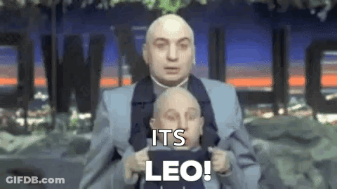 Bald Man In Suit Holding Smaller Man's Head GIF