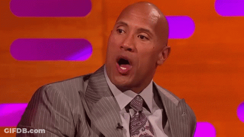 Bald Man In Suit Making Funny Face On Stage GIF