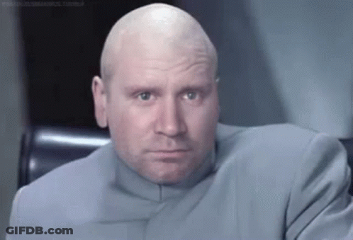 Bald Man In Suit Sitting In Chair GIF