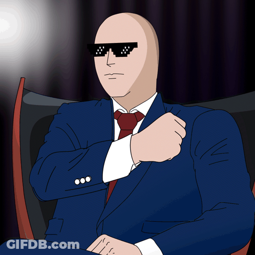 Bald Man In Suit Sitting GIF