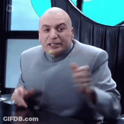 Bald Man In Suit Sitting With Hands Outstretched GIF