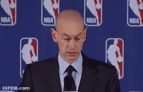 Bald Man In Suit Smiling At Microphone GIF