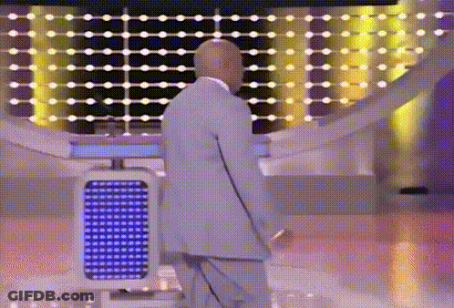 Bald Man In Suit Standing Before Blue Light GIF