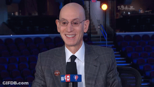 Bald Man In Suit Tie Smiling At Microphone GIF