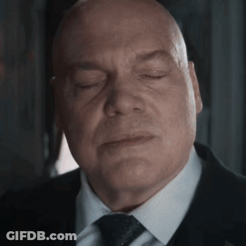 Bald Man In Suit With Eyes Closed GIF