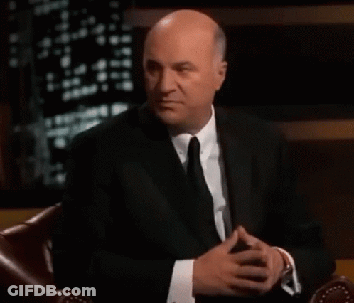 Bald Man In Suit With Hands Folded GIF