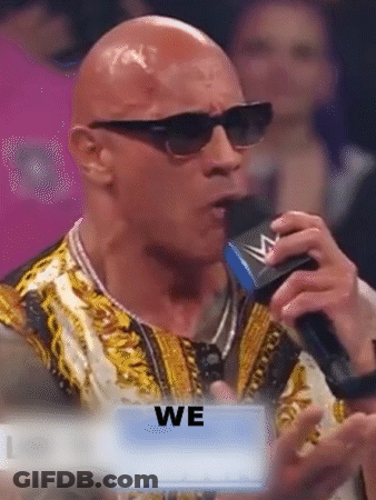 Bald Man In Sunglasses Speaking Into Microphone Holding Sign We GIF