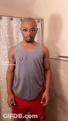 Bald Man In Tank Top And Red Shorts By Shower Curtain GIF