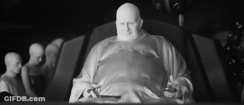 Bald Man In White Robe Sitting Black And White GIF