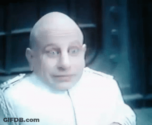 Bald Man In White Suit Making Funny Face GIF