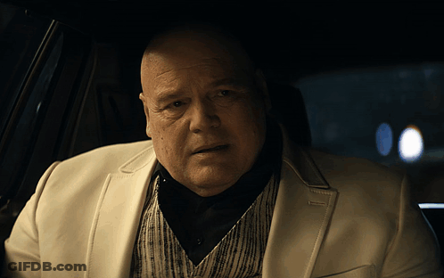 Bald Man In White Suit Sitting In Car GIF