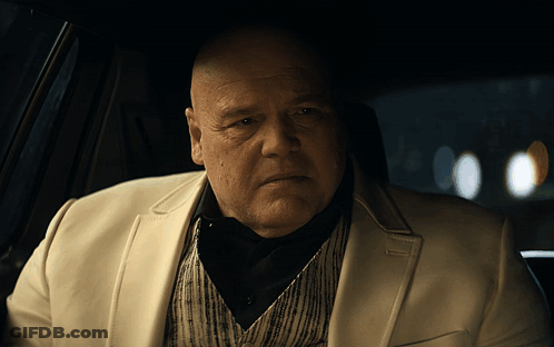 Bald Man In White Suit Sitting In Car GIF