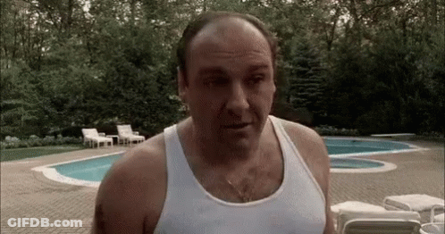 Bald Man In White Tank Top By Pool GIF