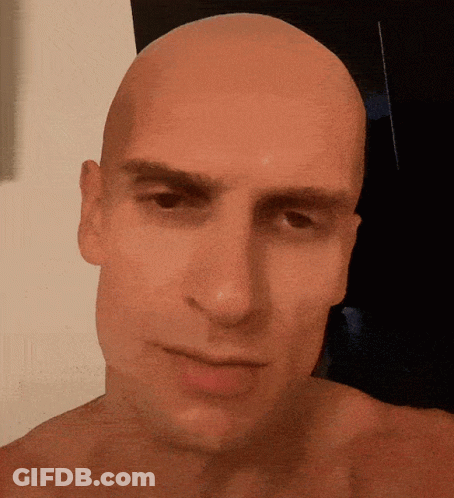 Bald Man Looking At Camera GIF