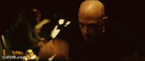 Bald Man Looking In Dark Room GIF