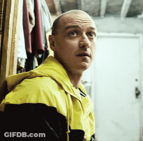 Bald Man Looking Sideways Yellow Black Jacket GIF