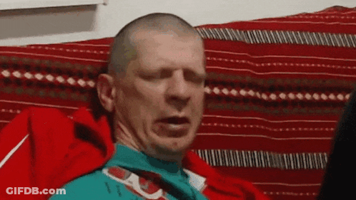 Bald Man Making Funny Face On Couch GIF