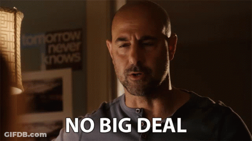 Bald Man Saying No Big Deal In Front Of Lamp GIF