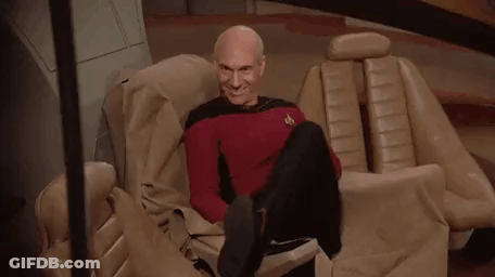 Bald Man Sitting Crossed Legs Smiling GIF