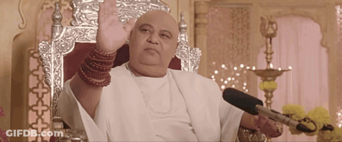 Bald Man Sitting In Chair With Microphone GIF