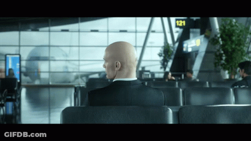 Bald Man Sitting In Waiting Area Sign 121 GIF