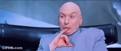 Bald Man Sitting With Finger To Mouth GIF