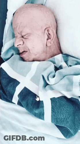 Bald Man Sleeping In Bed With Nike Blanket GIF