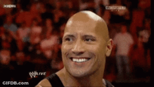 Bald Man Smiling At Wrestling Match GIF