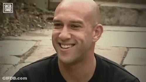 Bald Man Smiling In Black Shirt GIF