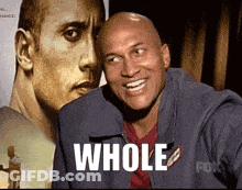 Bald Man Smiling In Front Of Dwayne Johnson With Word Whole GIF