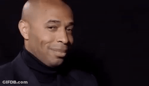 Bald Man Smiling In Suit And Turtleneck GIF