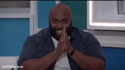 Bald Man Smiling Sitting On Couch GIF