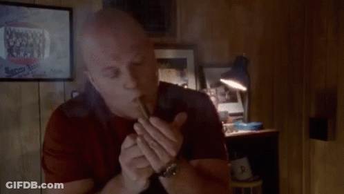 Bald Man Smoking Cigar By Lamp GIF