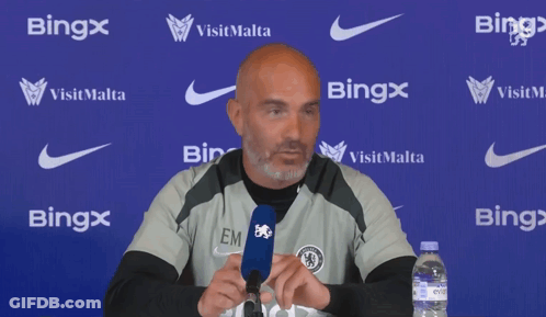 Bald Man Speaking Into Microphone In Front Of Bing Wall GIF