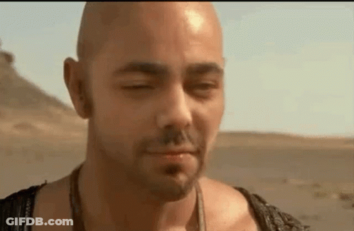 Bald Man Standing In Desert With Eyes Closed And Mouth Open GIF