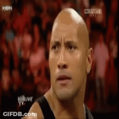 Bald Man Standing In Front Of Crowd GIF