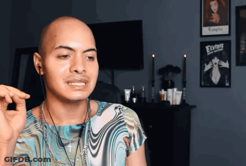 Bald Man Standing In Front Of Elvis Poster GIF