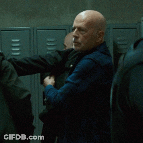 Bald Man Standing In Front Of Lockers GIF