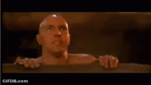 Bald Man Sticking Head Out Of Wall Hole GIF