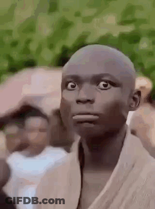 Bald Man Surprised In Front Of Crowd GIF