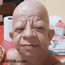 Bald Man Taking Selfie With Toilet Paper Rolls GIF