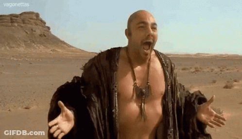 Bald Man With Arms Outstretched In Desert GIF