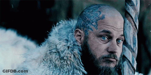 Bald Man With Beard And Forehead Tattoo Next To Pole GIF