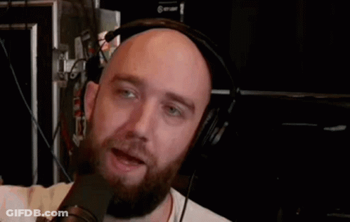 Bald Man With Beard And Headphones Talking Into Microphone GIF