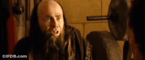 Bald Man With Beard And Long Hair Talking To Another Man GIF