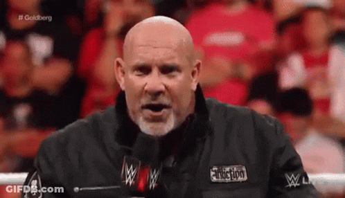 Bald Man With Beard At Microphone GIF